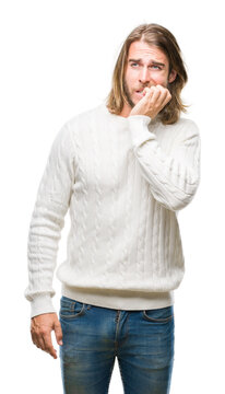 Young handsome man with long hair wearing winter sweater over isolated background looking stressed and nervous with hands on mouth biting nails. Anxiety problem.