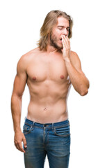 Young handsome shirtless man with long hair showing sexy body over isolated background bored yawning tired covering mouth with hand. Restless and sleepiness.