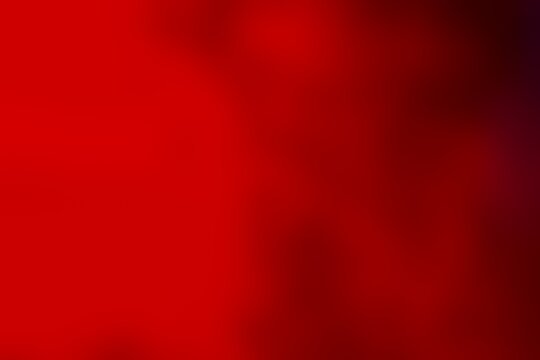 Abstract blurred background image of red colors gradient used as an illustration. Designing posters or advertisements.