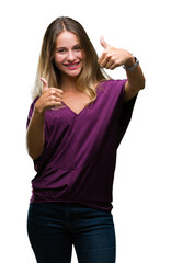 Obraz na płótnie Canvas Young beautiful blonde elegant woman over isolated background approving doing positive gesture with hand, thumbs up smiling and happy for success. Looking at the camera, winner gesture.