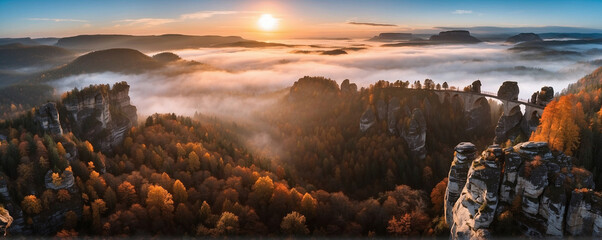 Saxon, Germany - Aerial panoramic view of the beautiful Saxon Switzerland National Park near Dresden on a foggy autumn morning with Bastei bridge