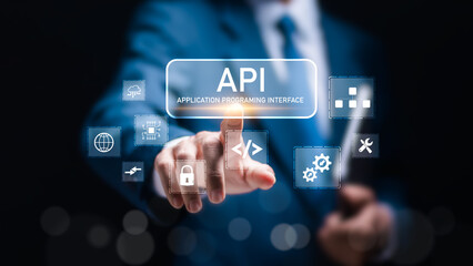 API Application Programming Interface concept. Businessman touch virtual screen of API icon Software development tool.