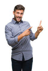 Fototapeta premium Young handsome man over isolated background smiling and looking at the camera pointing with two hands and fingers to the side.