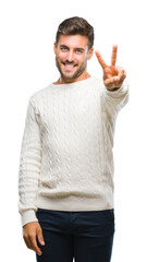 Young handsome man wearing winter sweater over isolated background smiling looking to the camera...