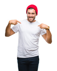 Young handsome man over isolated background looking confident with smile on face, pointing oneself with fingers proud and happy.