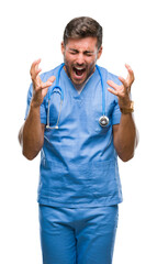 Young handsome doctor nurse man over isolated background celebrating mad and crazy for success with...