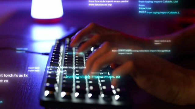 In a close-up side view, hands move rapidly over a keyboard. Yellow and blue lights are illuminating the scene. As the typing continues, fragments of various codes materialize on the screen.
