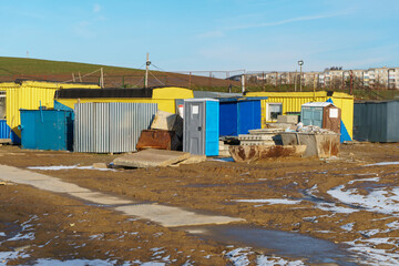 Mobile metal containers for the placement of a work crew on a construction site in winter. A temporary residential town of builders. A simple heated building to accommodate workers