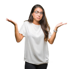 Young beautiful arab woman wearing glasses over isolated background clueless and confused...