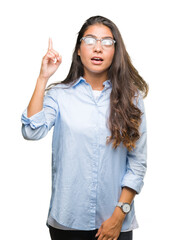 Young beautiful arab woman wearing glasses over isolated background pointing finger up with successful idea. Exited and happy. Number one.
