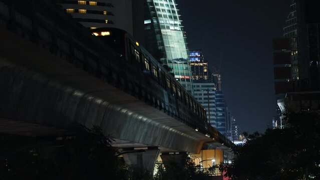 modern city, train moving above ground between high-rise buildings, urban view, city subway bts skytrain, passenger transportation