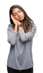 Young beautiful arab woman wearing sunglasses over isolated background sleeping tired dreaming and posing with hands together while smiling with closed eyes.