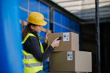Warehouse receiver kneeling inside of truck in cargo area, trailer, barcode scanning delivered...