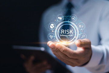 Businessman use tablet with Risk analysis in business decisions. Risk control and management strategies for risky businesses. Risk management concept.