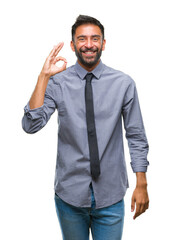 Adult hispanic business man over isolated background smiling positive doing ok sign with hand and fingers. Successful expression.