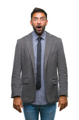 Fototapeta premium Adult hispanic business man over isolated background afraid and shocked with surprise expression, fear and excited face.