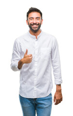 Adult hispanic man over isolated background doing happy thumbs up gesture with hand. Approving...