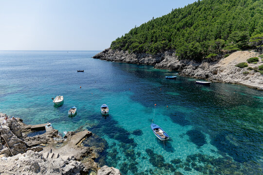 A bay in Mljet Island, Croatia. Tourist destination in the Adriatic sea. Beautiful place for summer holidays and vacations. Boats docked in the bay.