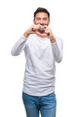 Adult hispanic man over isolated background smiling in love showing heart symbol and shape with hands. Romantic concept.