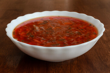 Red borscht in a white plate