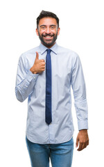 Adult hispanic business man over isolated background doing happy thumbs up gesture with hand. Approving expression looking at the camera with showing success.