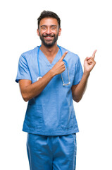 Adult hispanic doctor or surgeon man over isolated background smiling and looking at the camera...