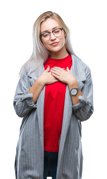 Young blonde business woman wearing fashion jacket over isolated background smiling with hands on chest with closed eyes and grateful gesture on face. Health concept.