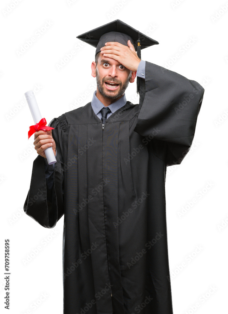 Poster young handsome graduated man holding degree over isolated background stressed with hand on head, sho