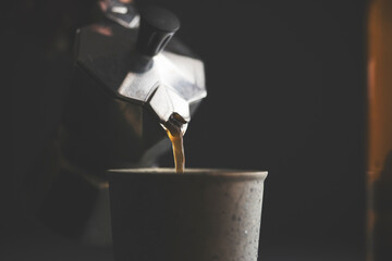 Pouring coffee with a moka pot, close up shot
