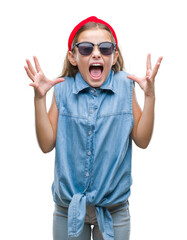 Young beautiful girl wearing sunglasses over isolated background celebrating crazy and amazed for success with arms raised and open eyes screaming excited. Winner concept