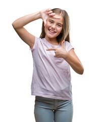 Young beautiful girl over isolated background smiling making frame with hands and fingers with happy face. Creativity and photography concept.