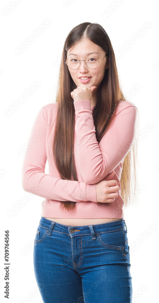 Canvas Prints Young Chinese woman over isolated background wearing glasses looking confident at the camera with smile with crossed arms and hand raised on chin. Thinking positive.