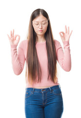 Young Chinese woman over isolated background wearing glasses relax and smiling with eyes closed doing meditation gesture with fingers. Yoga concept.