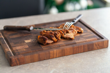 Grilled pork steak slices on a wooden cutting board. High quality photo