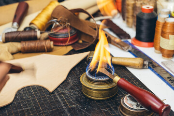 Tools and leather at cobbler workplace. Set of leather craft tools on wooden background. - obrazy, fototapety, plakaty