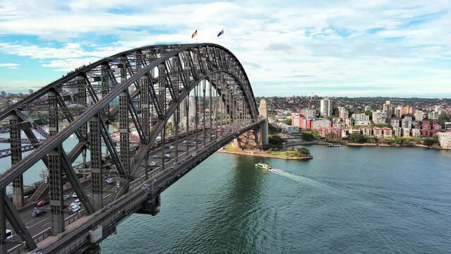 Sydney, Australia: Aerial view of iconic landmark Sydney Harbour Bridge in capital city of Australian state of New South Wales, North Sydney Business District on horizon