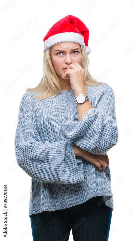 Poster Young caucasian woman wearing christmas hat over isolated background looking stressed and nervous with hands on mouth biting nails. Anxiety problem.