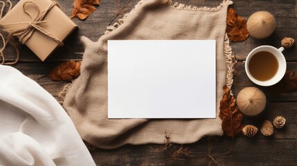 Cozy Autumn Hygge: Craft Paper Composition with Tea, Gift Box, and Knitted Scarf on Wooden Desk - Winter Holiday Concept
