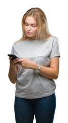 Young caucasian woman sending message using smartphone over isolated background with a confident expression on smart face thinking serious