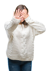 Young beautiful caucasian woman wearing winter sweater over isolated background covering eyes with hands and doing stop gesture with sad and fear expression. Embarrassed and negative concept.