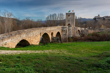 Medieval Bridge of Frías over the Ebro River and Church of San Vicente in the background, Burgos,...