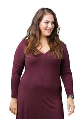 Beautiful and attractive plus size young woman wearing a dress over isolated background looking away to side with smile on face, natural expression. Laughing confident.