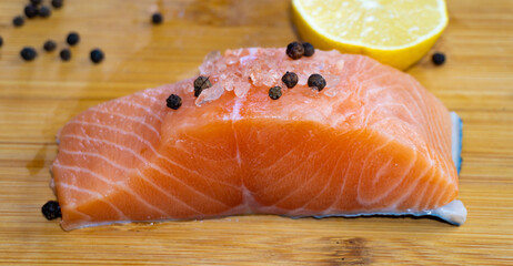 Fresh raw salmon fillet on wooden cutting board