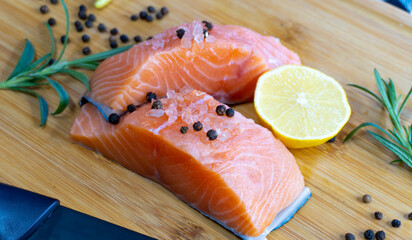 Fresh raw salmon fillet on wooden cutting board