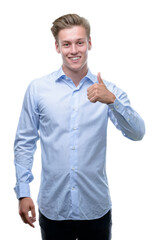 Young handsome blond man happy with big smile doing ok sign, thumb up with fingers, excellent sign