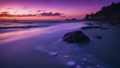 Obraz premium A Secluded Beach with Bioluminescent Waves at Night, the shoreline aglow with ethereal blue light