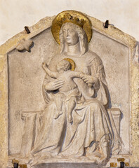 TREVISO, ITALY - NOVEMBER 8, 2023: The relief of Madonna with the Jesus child and butterfly (symbol of the soul) in church Chiesa di San Vito e Santa Lucia probably by Filippo Calendario (14. cent). - 709788354
