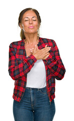 Middle age adult woman wearing casual jacket over isolated background smiling with hands on chest with closed eyes and grateful gesture on face. Health concept.