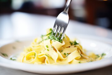 close-up on a fork twirling fettuccine alfredo