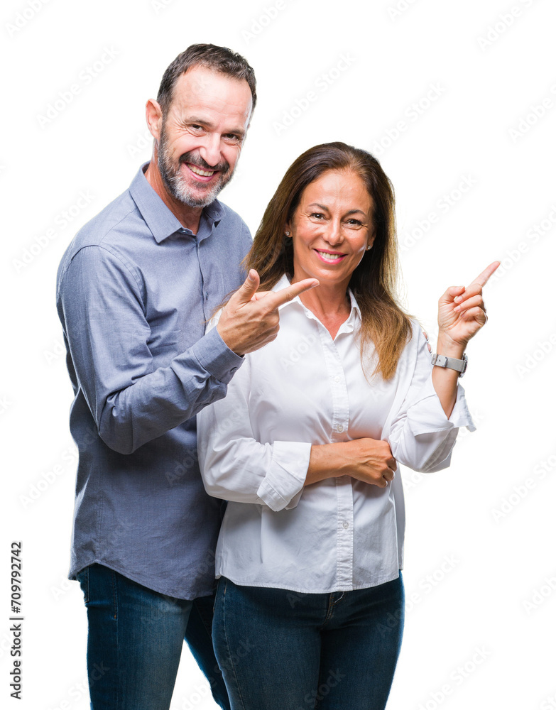 Sticker middle age hispanic business couple over isolated background with a big smile on face, pointing with